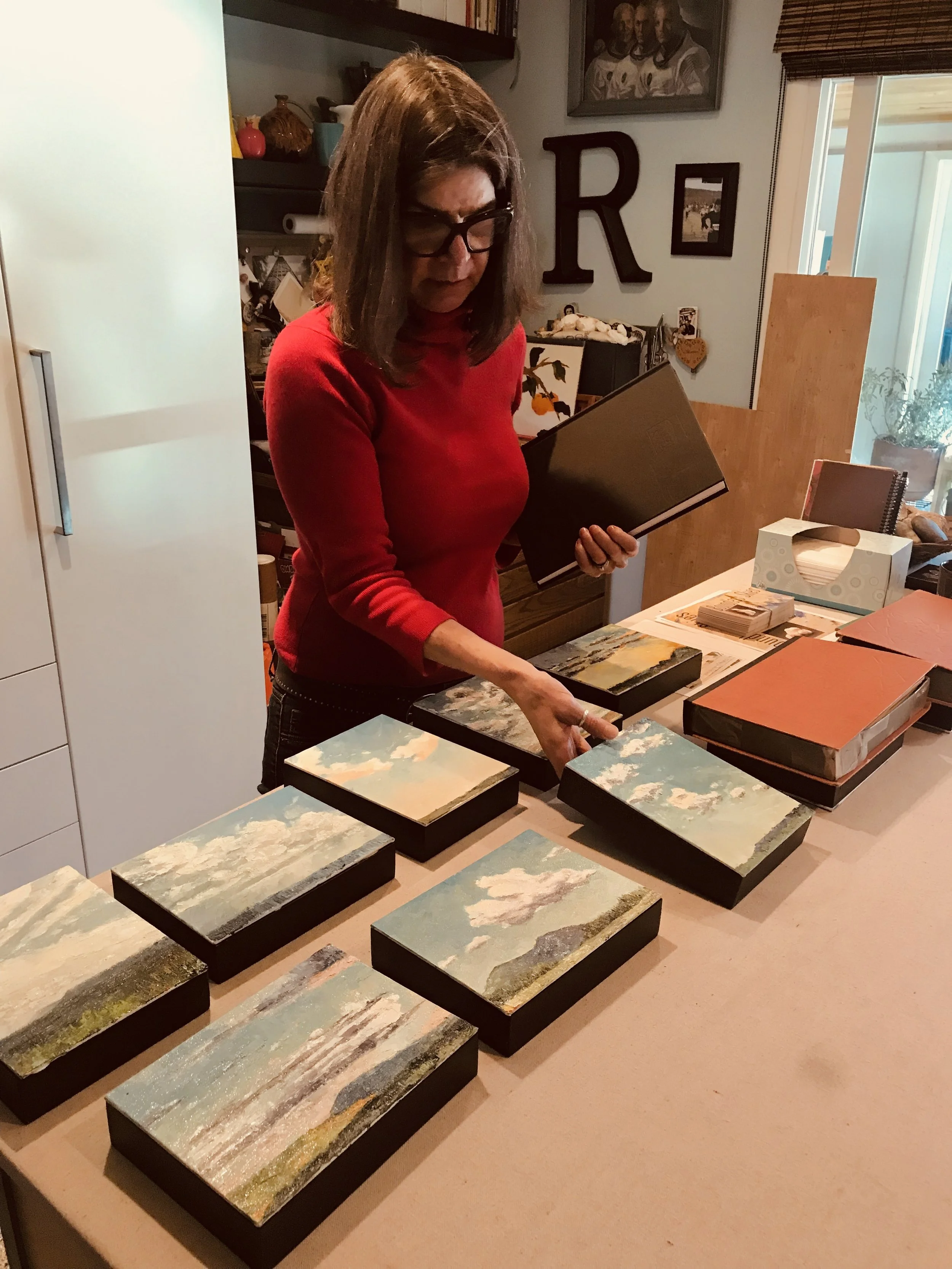 Rebekah in her studio displaying her 30 days of sky.