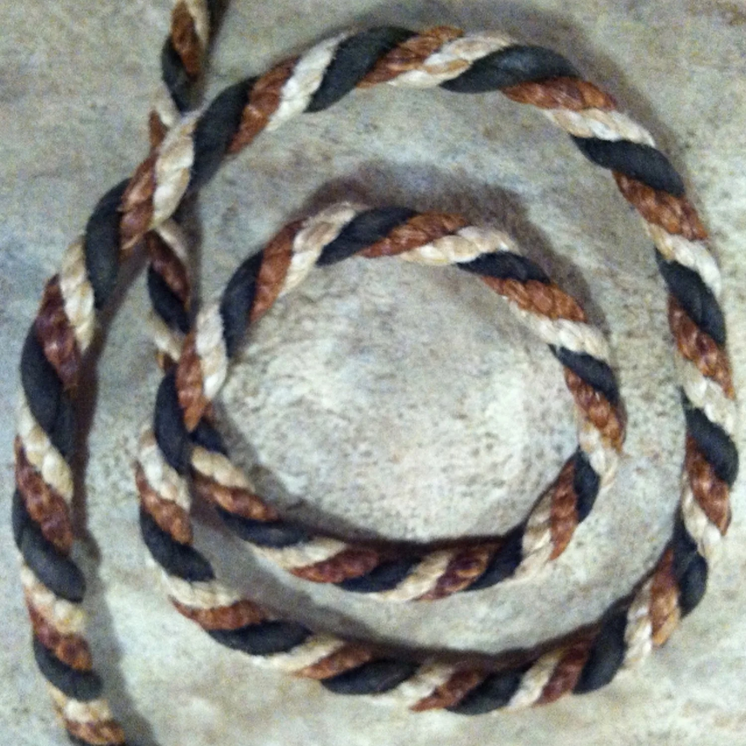 Three fibers twisted together: dogbane, milkweed & black buckskin