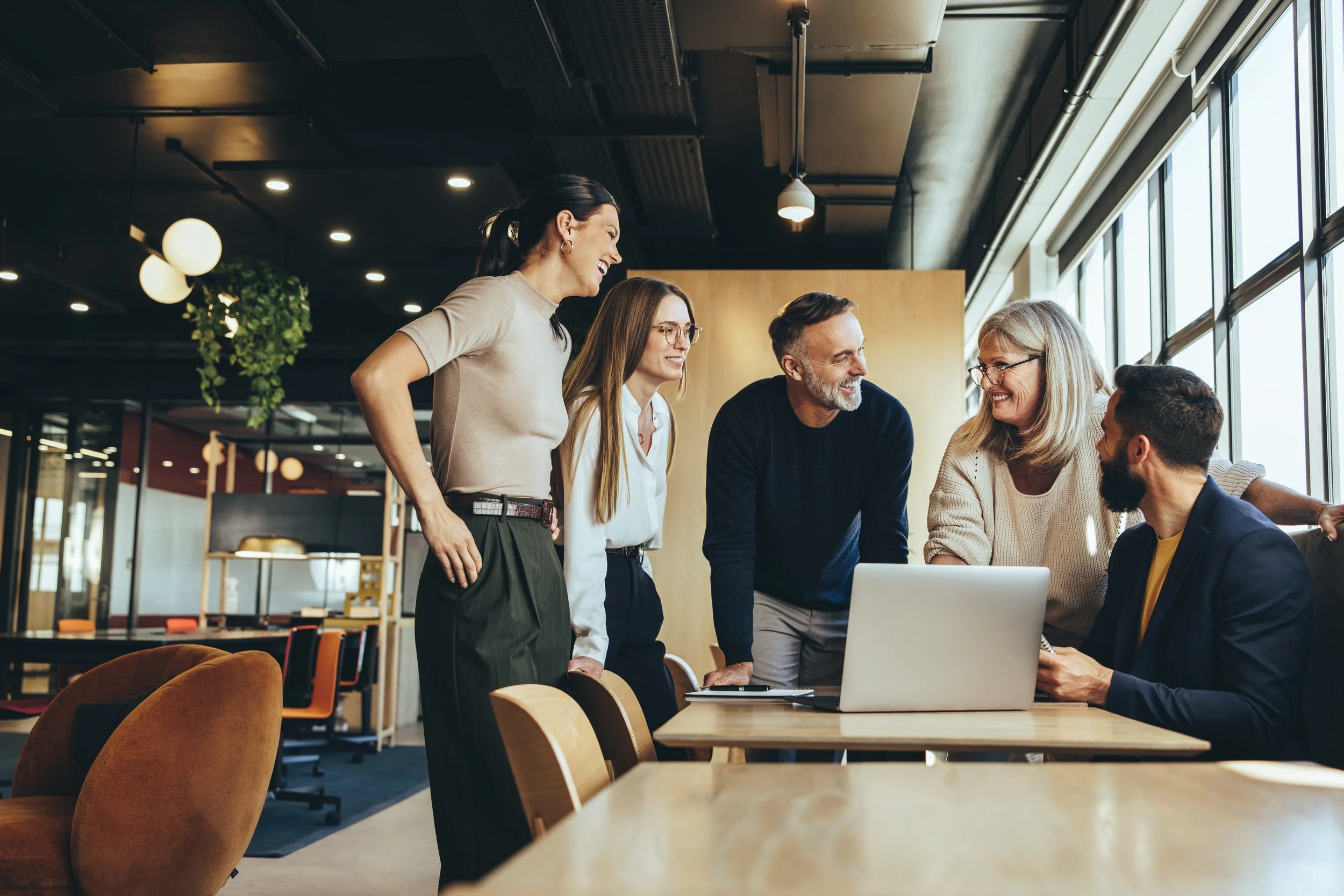 Happy Colleagues working around a Desk