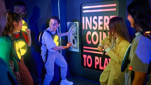 PacMAN Experience - Player putting penny in the slot