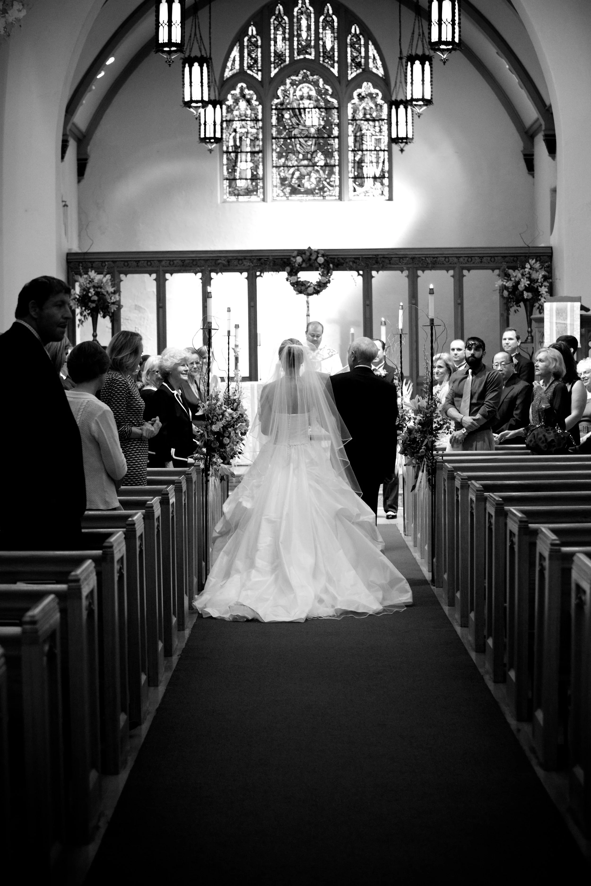 The father of the bride escorts her down the aisle.