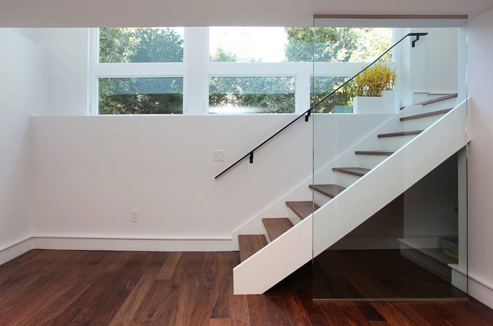 The first floor was pulled away from the window to provide a two storey space and flood the basement with light.