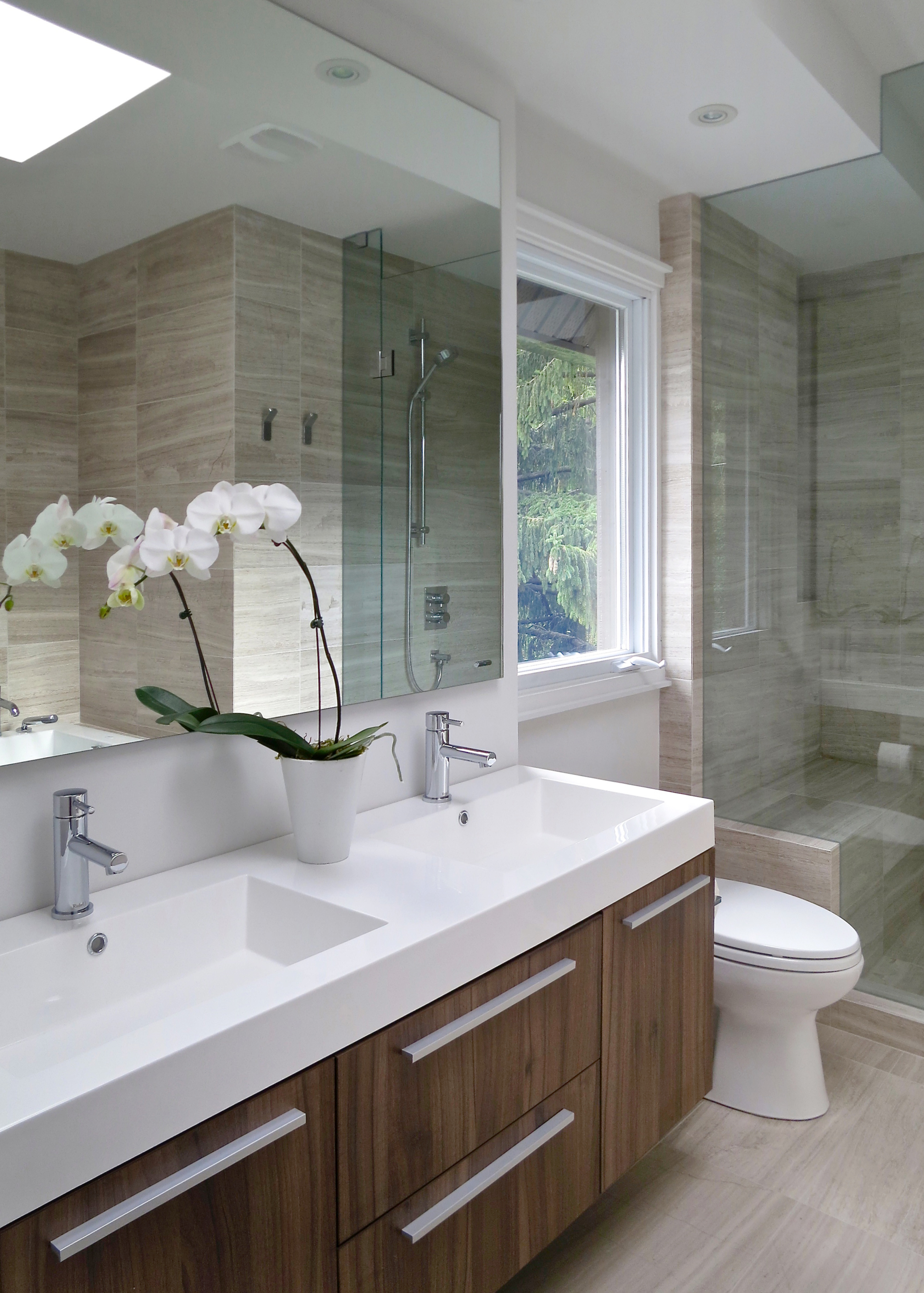 Raising the roof accommodated an additional ensuite bathroom with a separate frameless shower and platform bathtub.