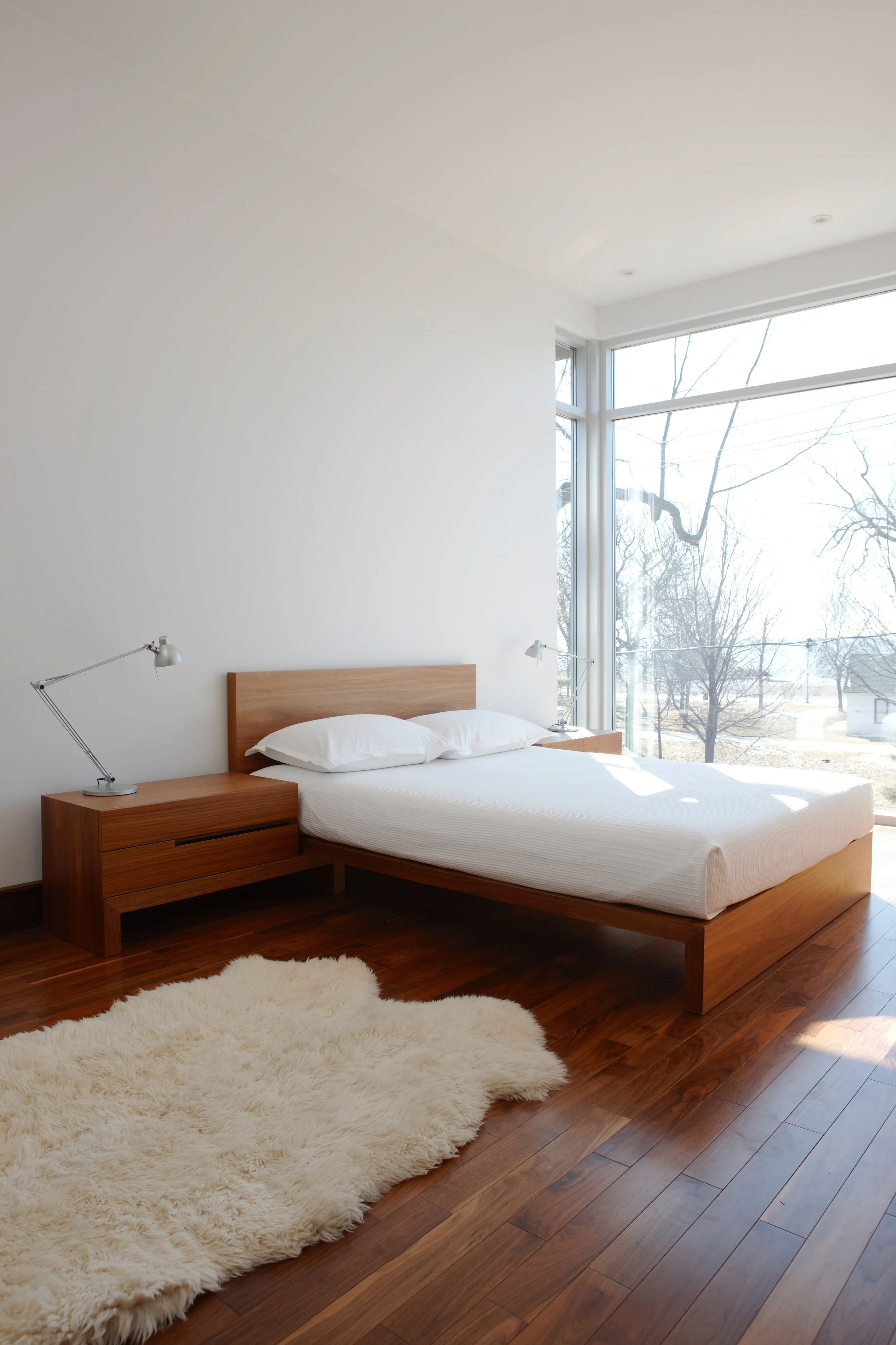 The master bedroom, at the tree canopy level, enjoys wall-to-wall, floor-to-ceiling windows which bathe the room in light. It is also buffered from the street and boardwalk by the strategic position of a spacious deck.