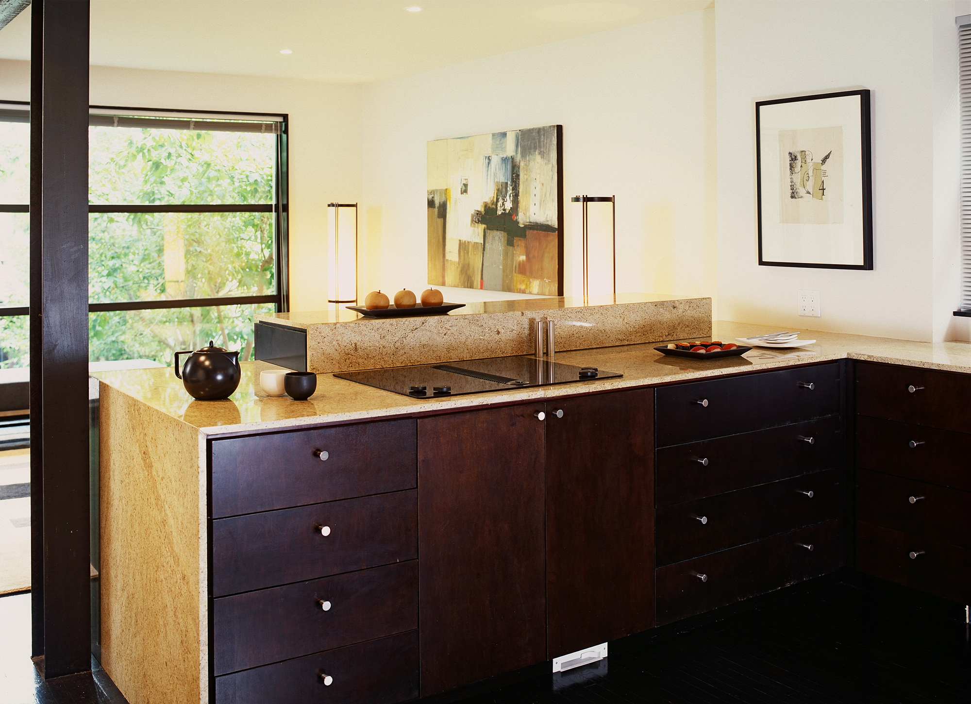 The granite counter wraps down the side of the custom cabinets.