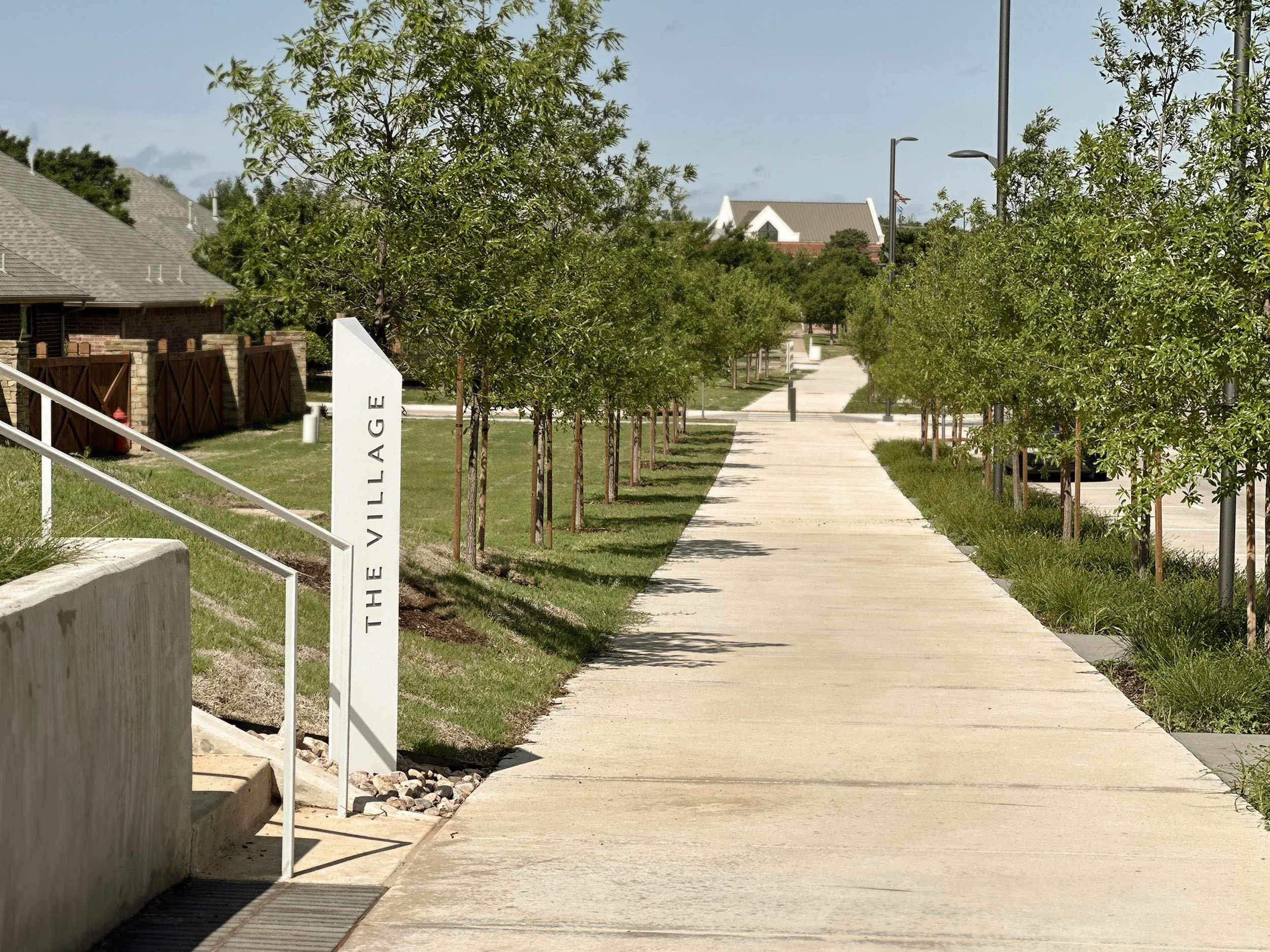  A tree lined ten foot path forms the spine of the linear park. Custom signage identifies key programs along the length of the park.  