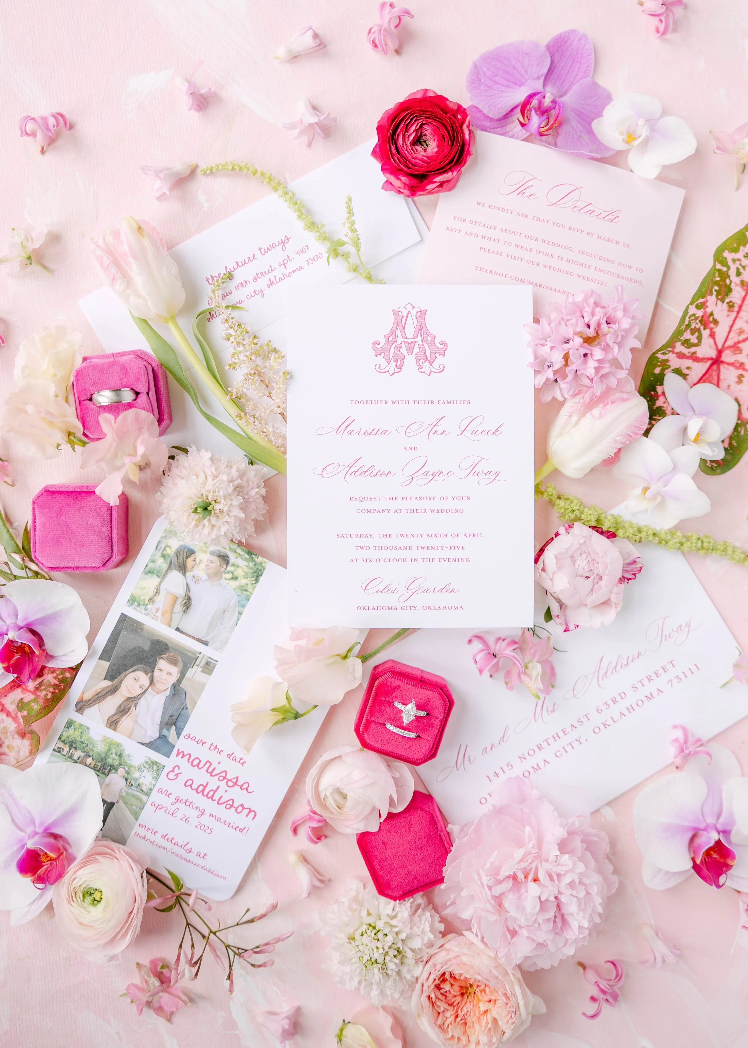 Pink wedding invitation surrounded by various pink and white flowers, petal confetti, a pink ring box with rings, and a collage of wedding photos on a pink background.