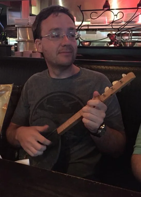 Playing the pan-jo — made out of an old pie plate