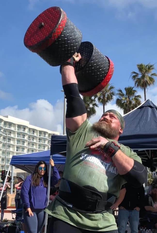 Chris Burke presses a circus dumbbell at California’s Strongest Man 2019