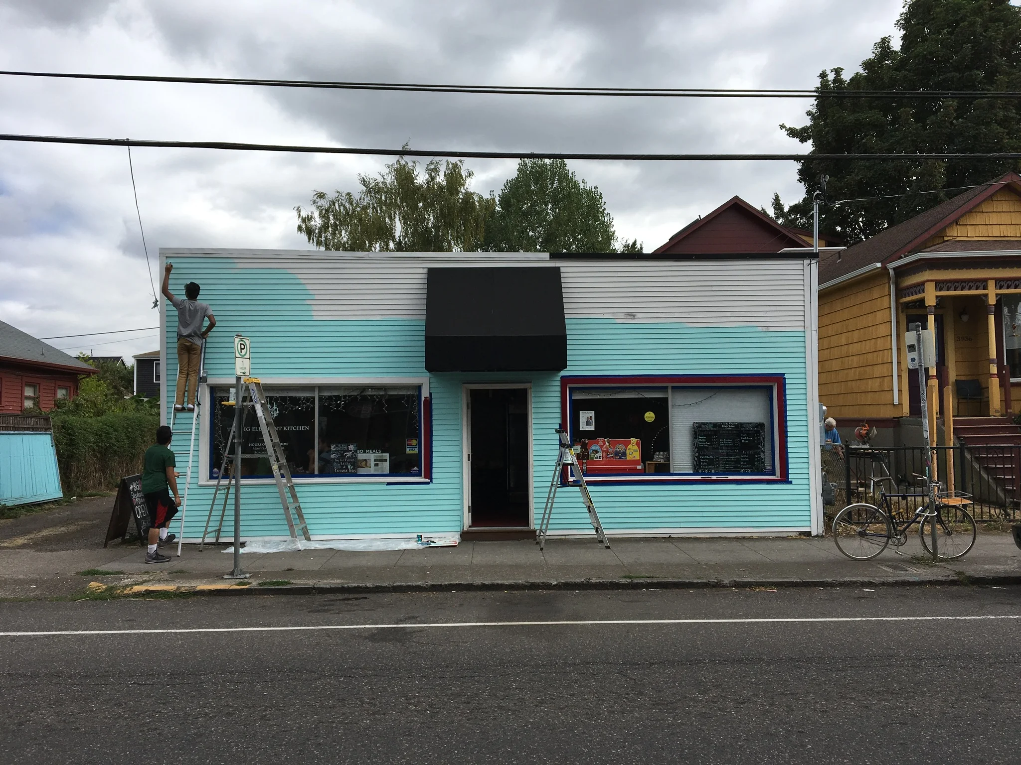  Owners, Deepak and Deon Sundar, painting their building.  