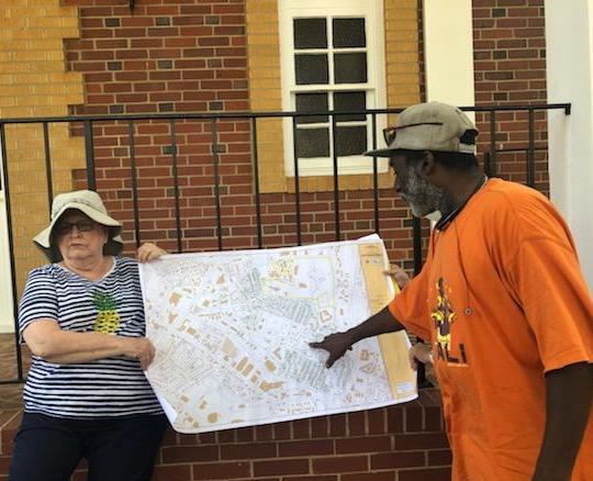 Canvassers from the Greenspon Center plan flyer distribution to invite Grier Heights residents to attend a Housing Partnership event to elicit community input for the upcoming development.