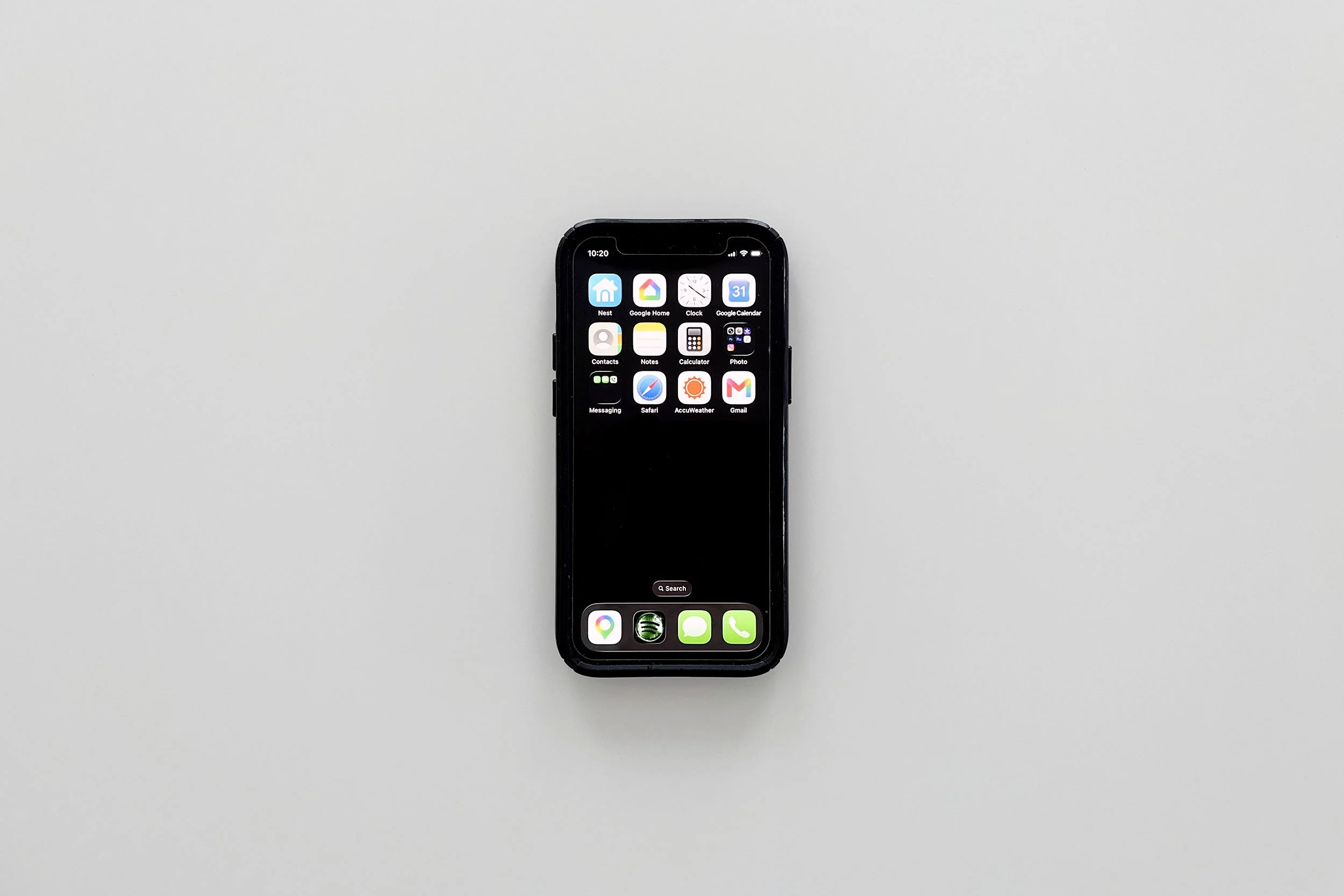 An iPhone centered on a white table