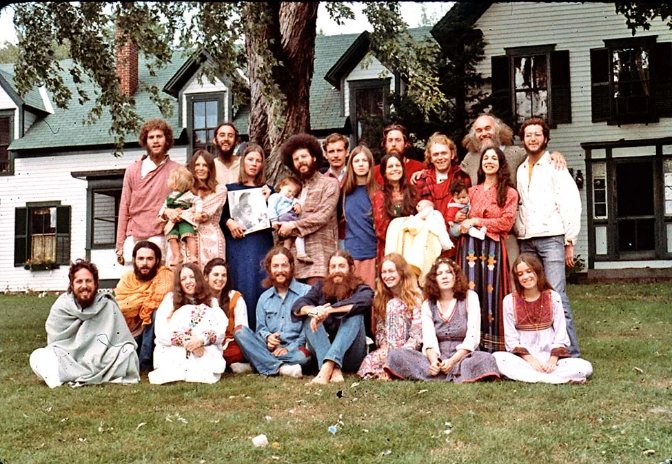 The woman in blue is holding a picture of Ram Dass’ guru, Neem Karoli Baba and RD is in the back row, second from right. (I did not take this picture.)