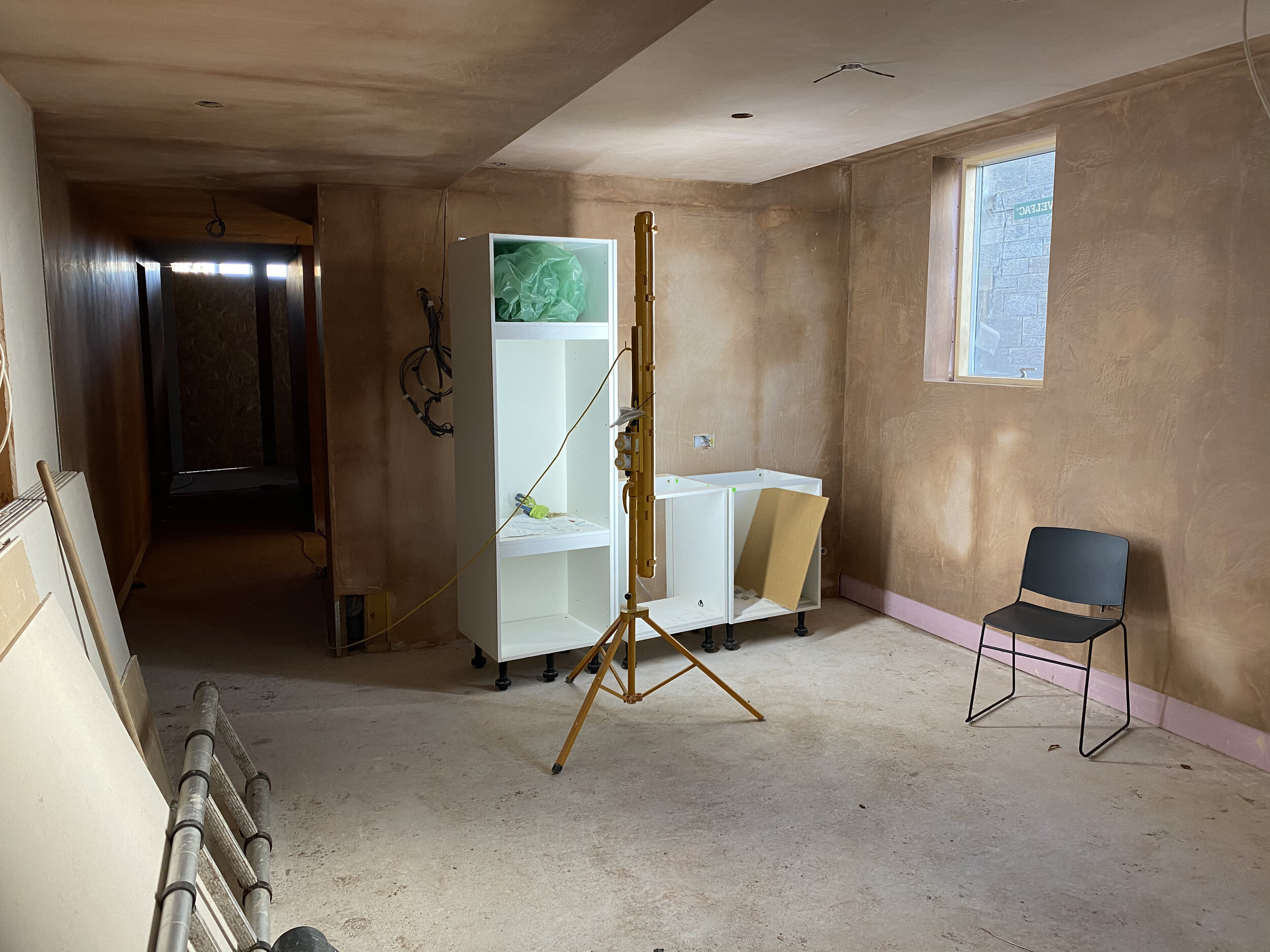 The kitchen units in the plastered extension