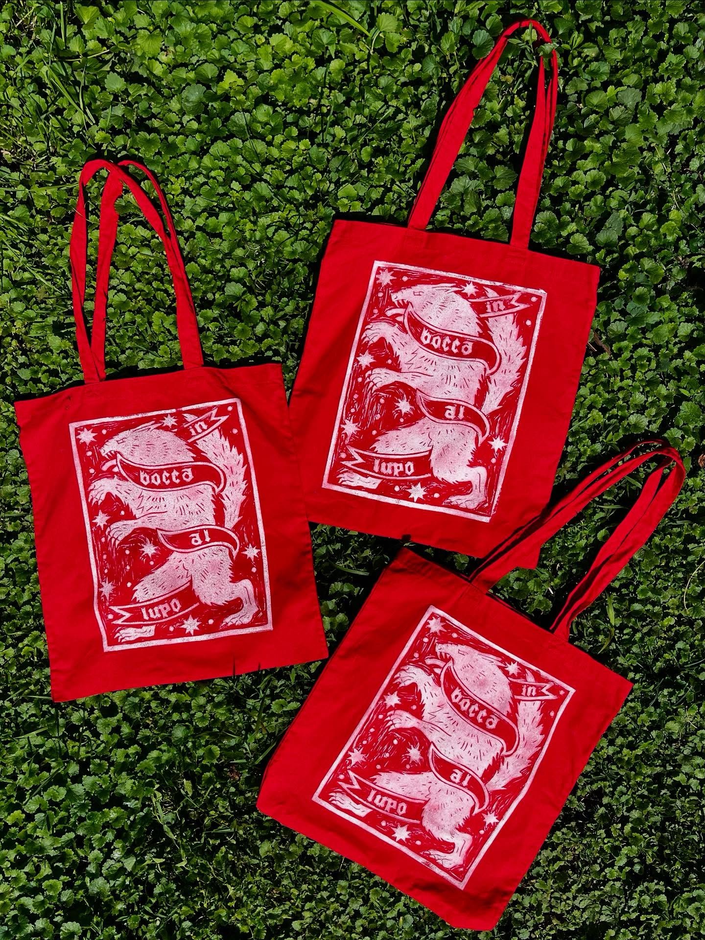 it&rsquo;s a lovely day to dry some tote bags in the sun! I finally got some more of the red &lsquo;in bocca al lupo&rsquo; tote bags printed and I&rsquo;m loving how they look in my garden. Shop update soon so share far and wide ❤️🐺✨