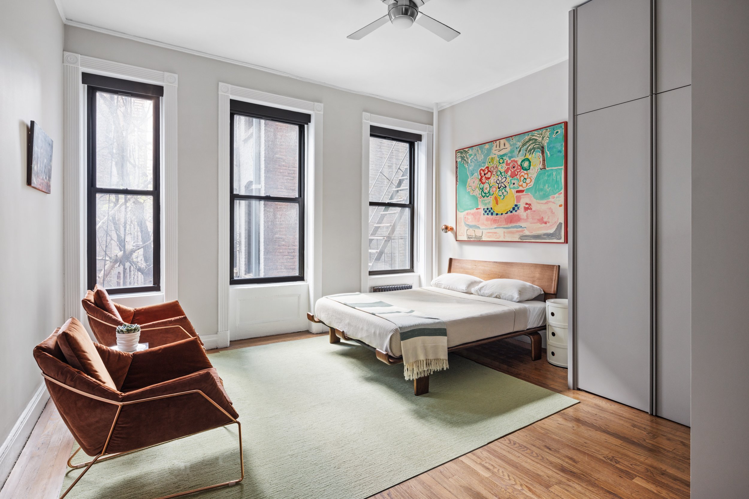 The culmination of the design was to create a custom floor-to-ceiling closet and chest-of-drawers that increased the apartment’s storage and concealed a movable wall to give the bedroom privacy. Photo credits: Brad Stein