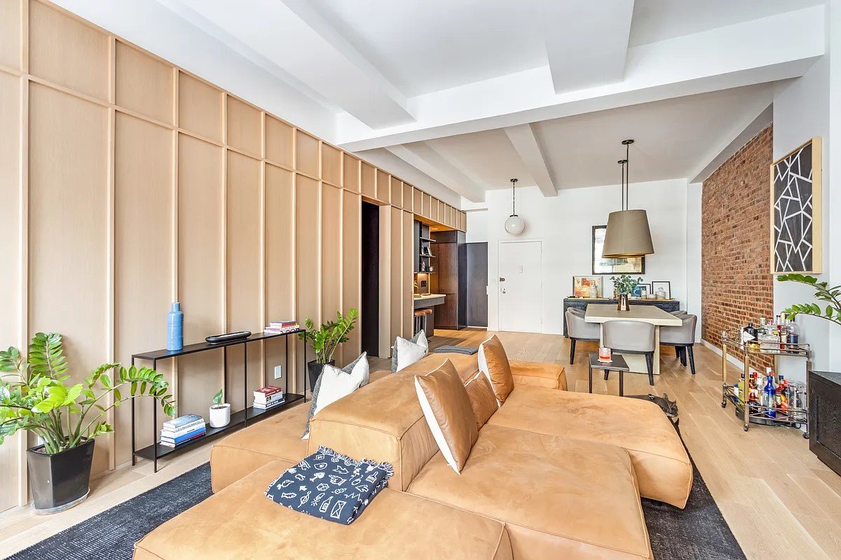 Our solution, featured in the New York Times Real Estate section, was to gut the apartment to expose the industrial bones of the space and introduce a millwork partition dividing the private spaces of the bedroom and bathroom along with a complete
