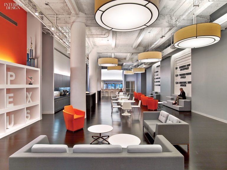 Grand office hallway with formal seating clusters and built in shelves.