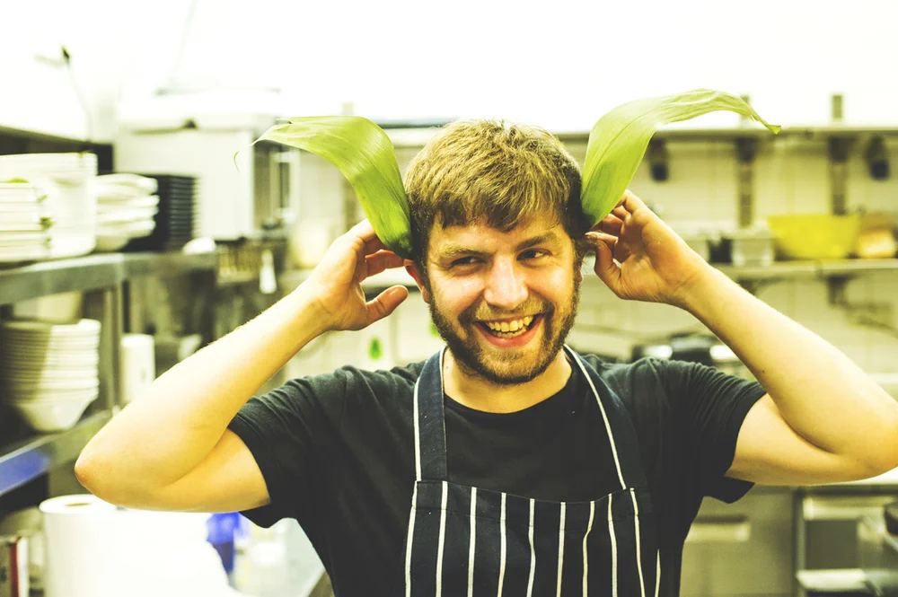 A young Sebby Holmes in the kitchen with lemongrass