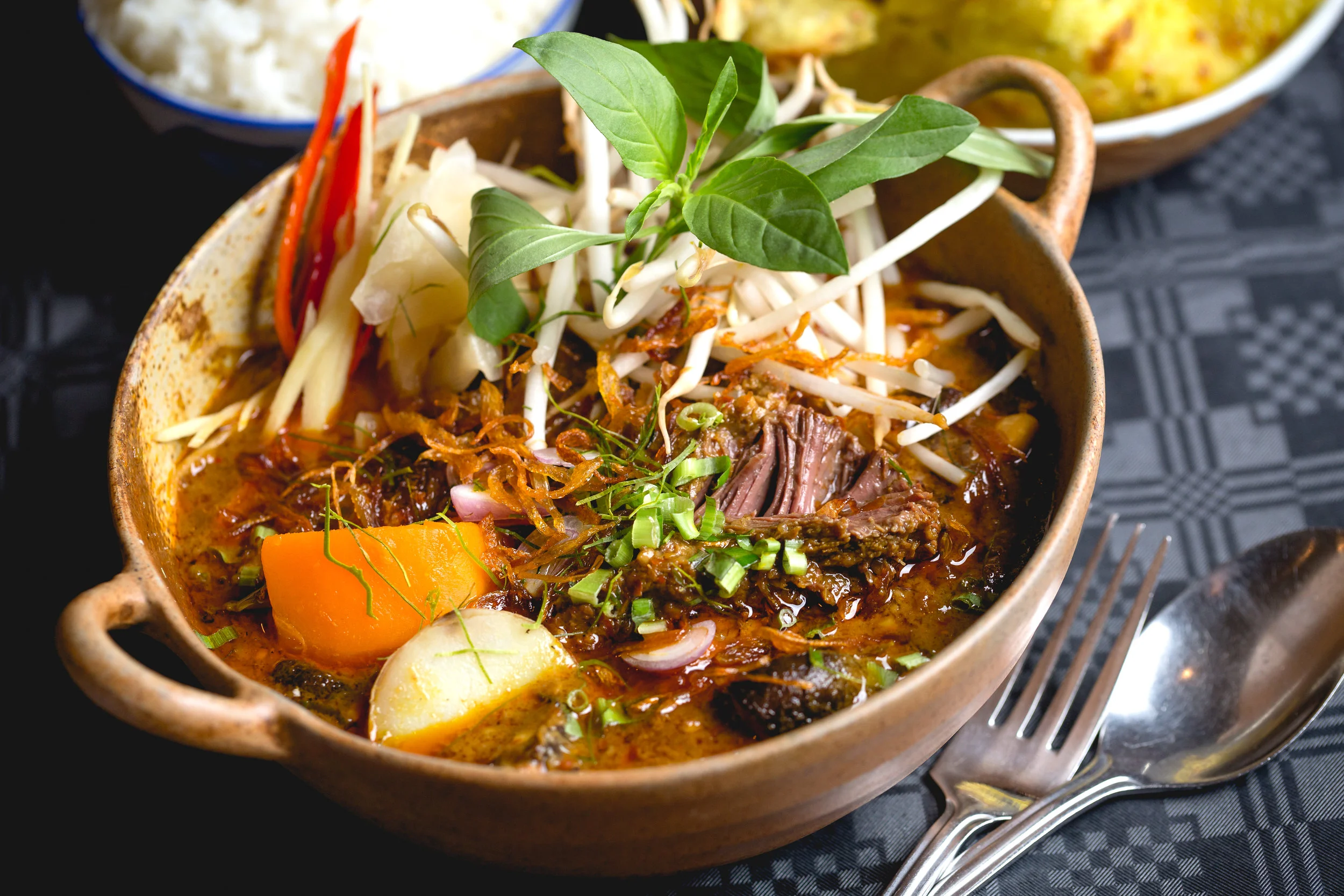 Aged beef cheeks braised in coconut cream, lemongrass and galangal served in a clay bowl with sweet basil, crispy shallots and jasmine rice, recipe by Sebby Holmes at Farang London
