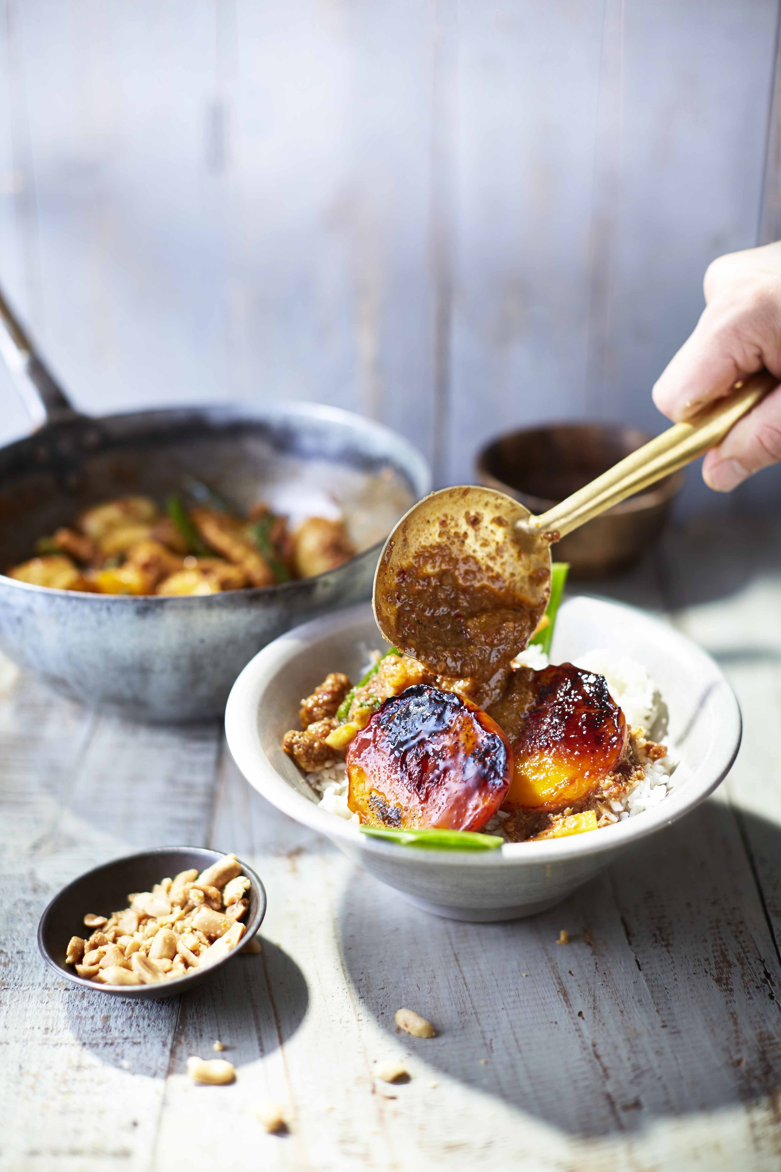 BBQ charred peaches on a vegan massaman curry with pineapple, peanuts and coriander, recipe by Sebby Holmes