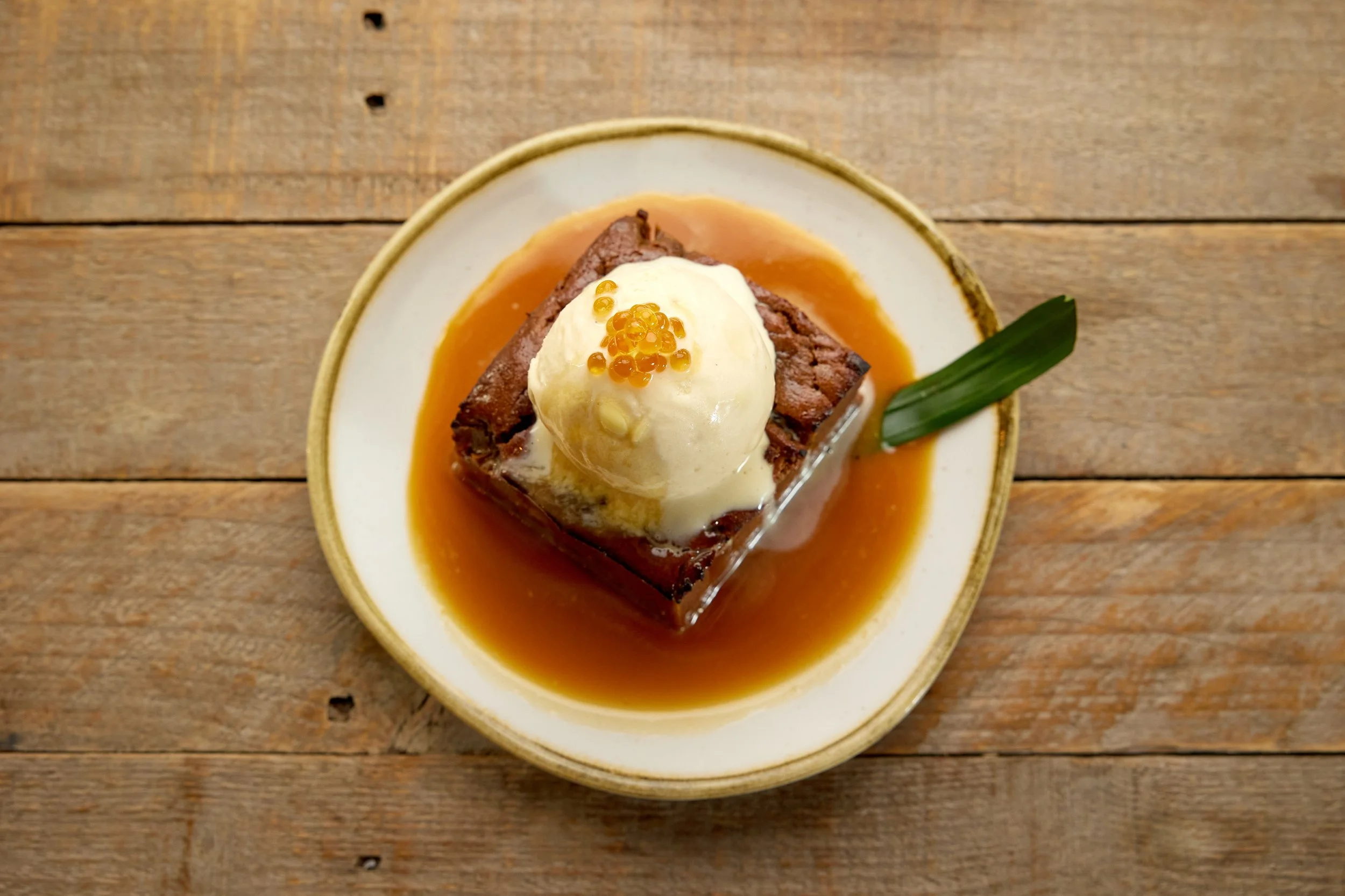 Spiced pumpkin and Sang Som rum sticky toffee pudding with coconut toffee sauce and toasted coconut