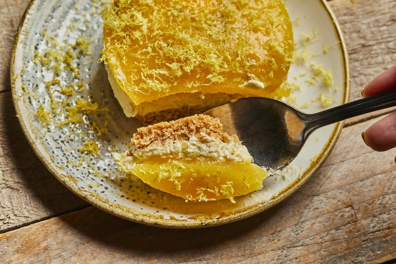 Passion fruit cheesecake, individual coconut-based rings with jelly and citrus zest, recipe by Sebby Holmes