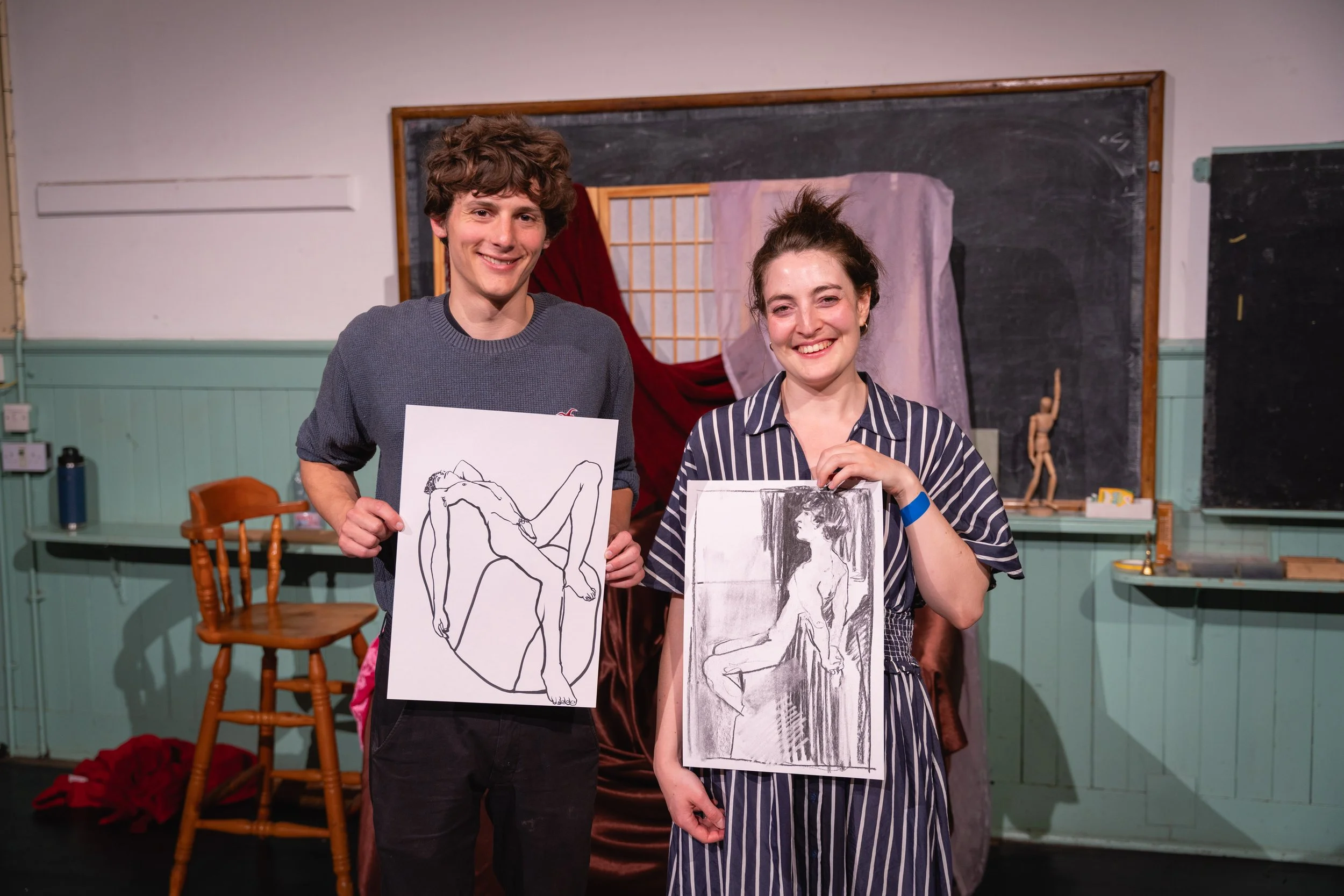 Here's Tommy with Katya's drawing of him, and me with mine. I like the little wooden guy grooving away in the background, too!