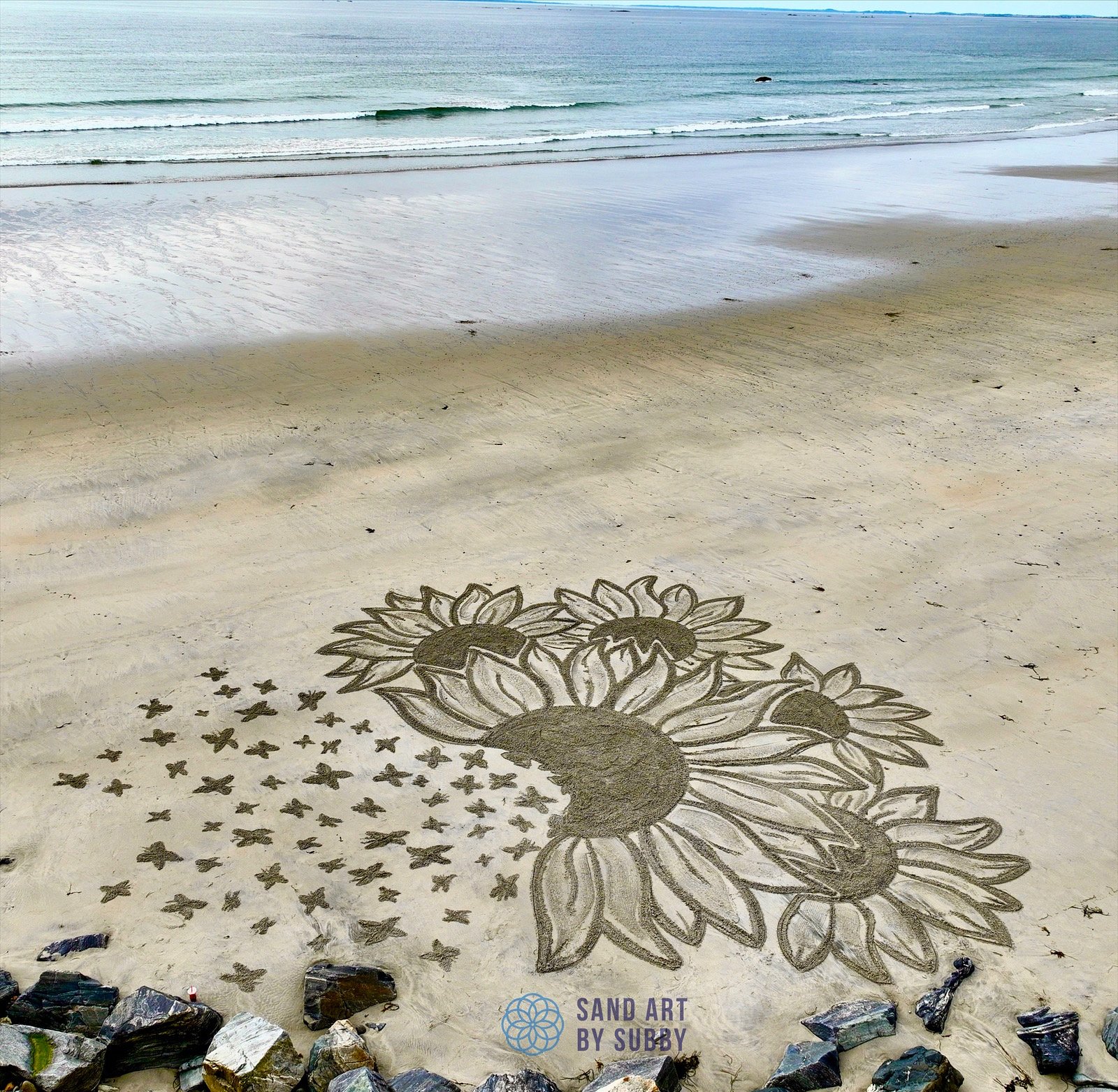 Hampton Beach NH artist creates huge sand paintings that wash away