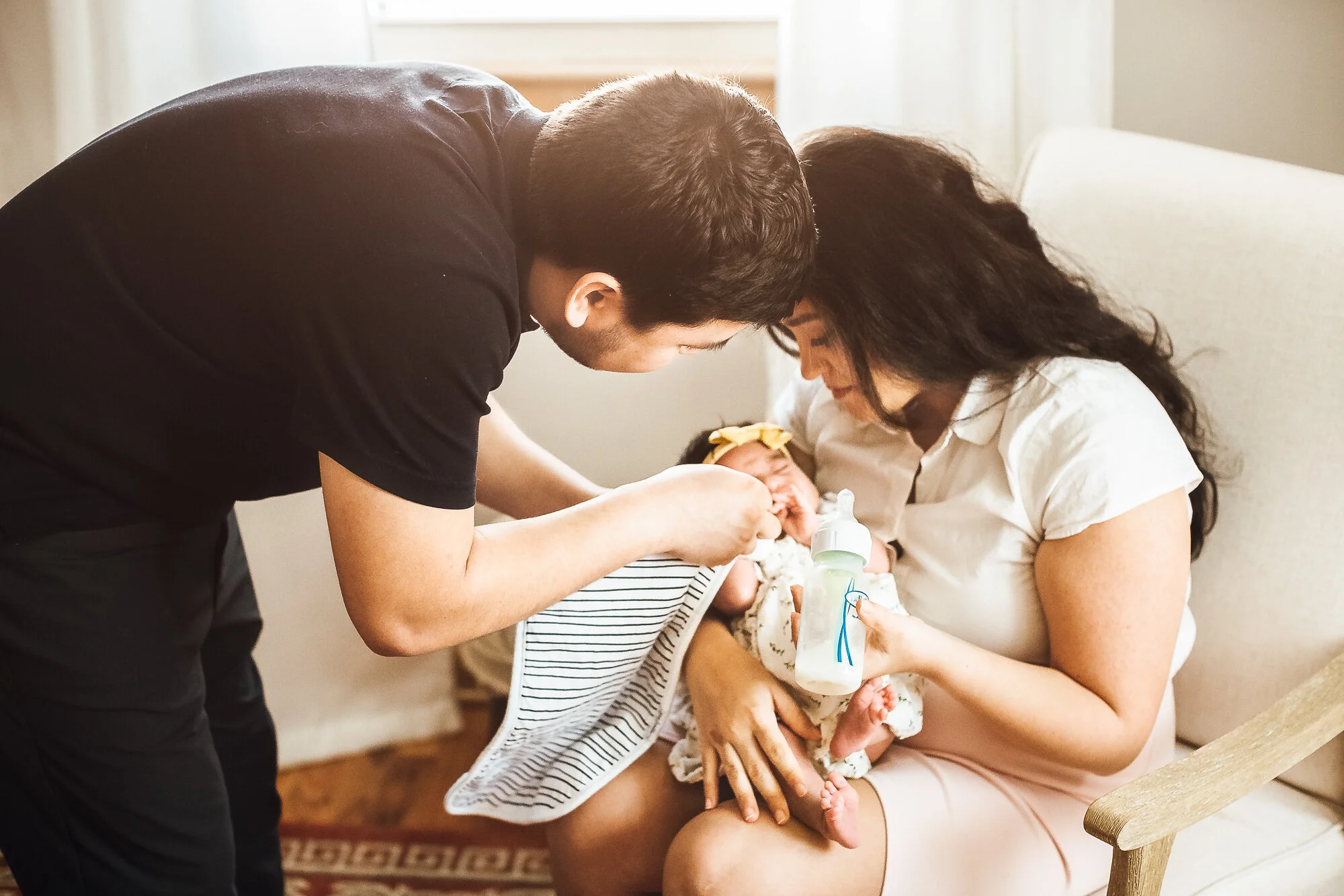 Parents taking care of newborn baby girl