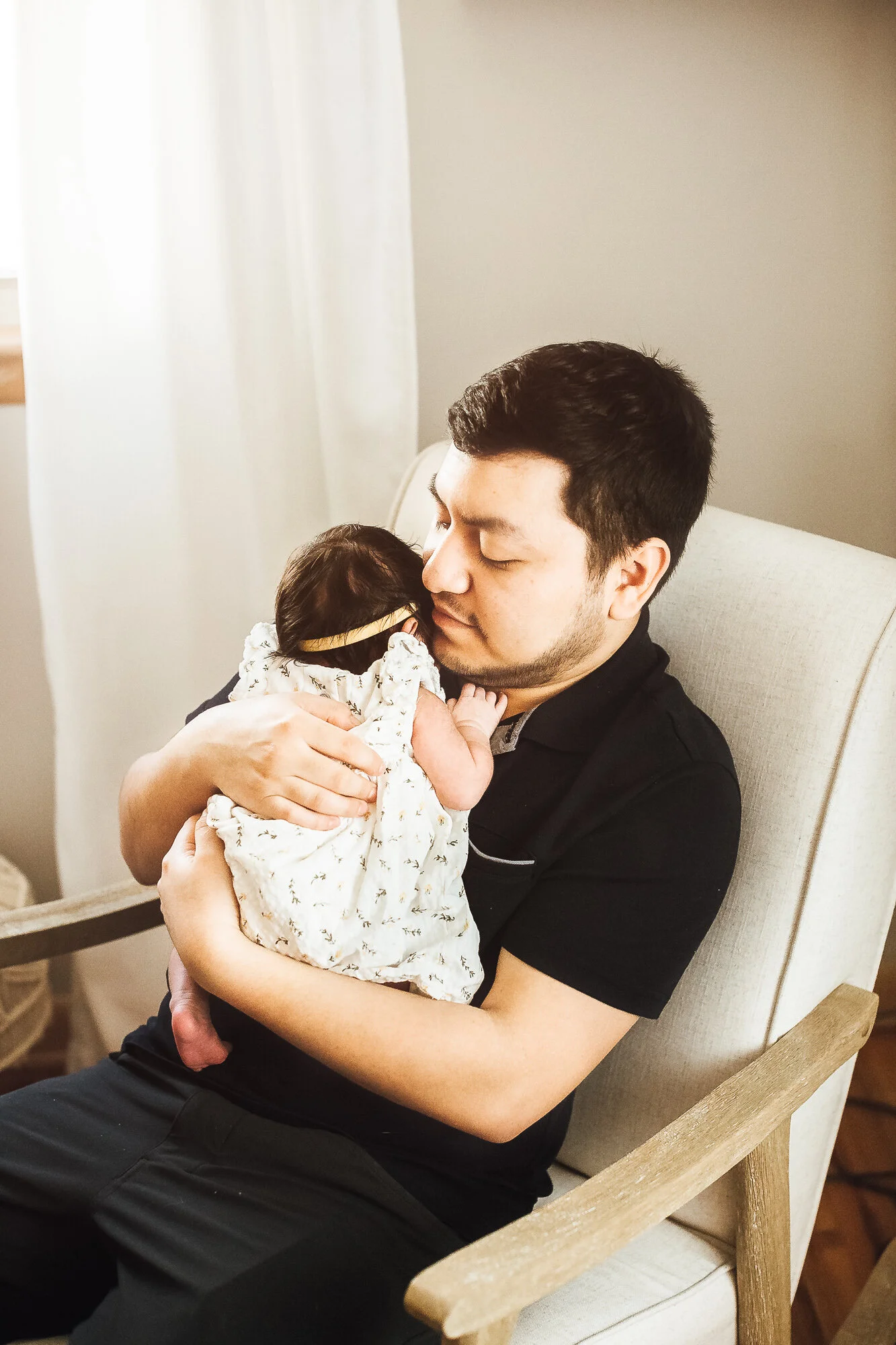 Father holding newborn baby girl