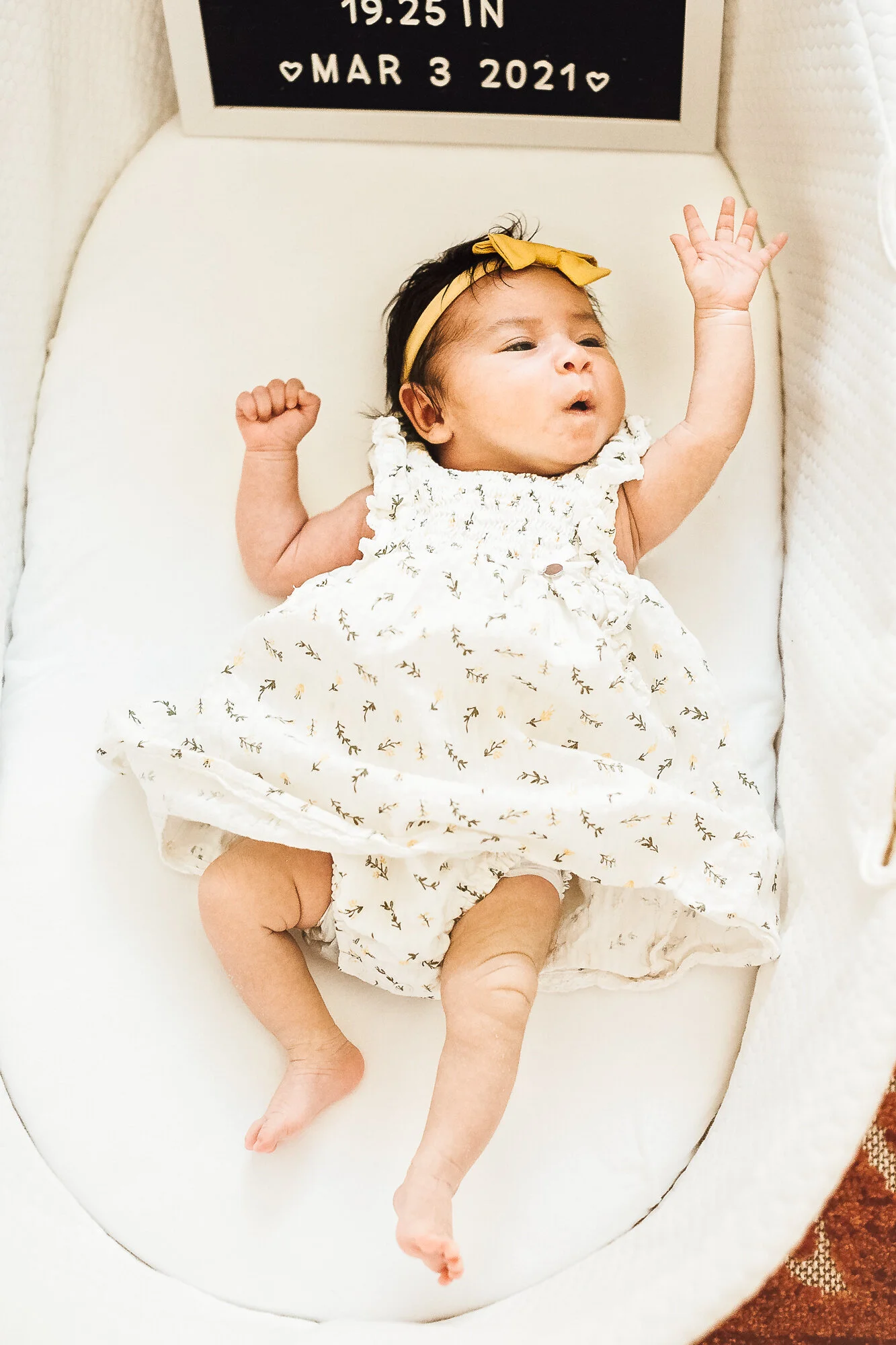 Newborn baby girl awake and reaching out