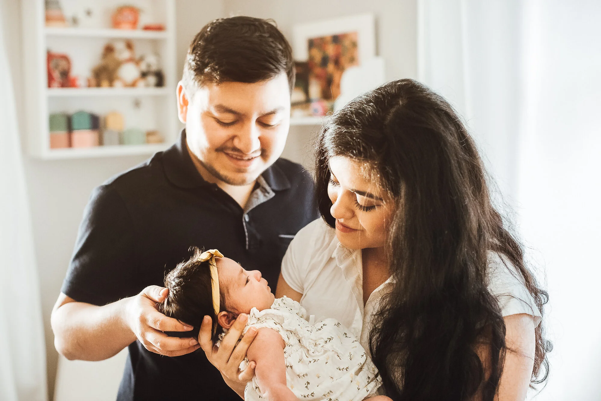 Newborn baby girl being held by parents