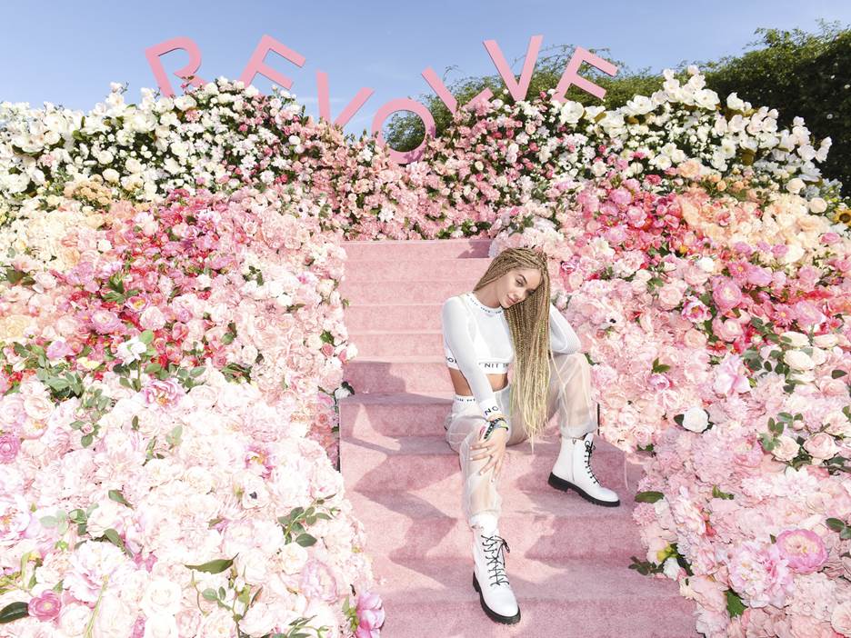 Jasmine Sanders poses at the #REVOLVEfestival flower wall