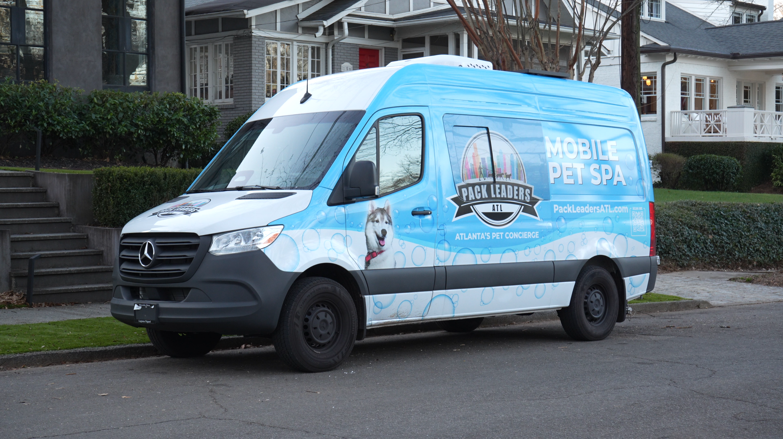 Pack Leaders ATL mobile pet grooming van parked in an Atlanta neighborhood
