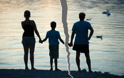 a-wife-a boy-and-her-husband-looking-at-a-lake-with-a-split-between-the-boy-and-the-man.jpg