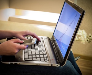 person-left-hands-on-a-laptop-computer-and-right-hand-on-a-cell-phone.jpg
