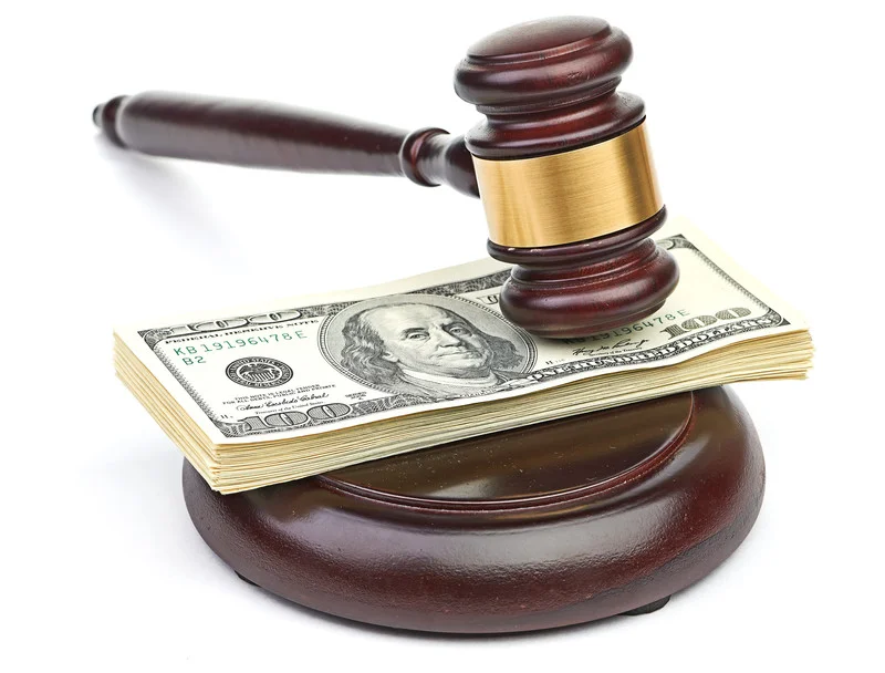 A judge’s gavel and cash representing attorney fee awards granted to one of the litigants