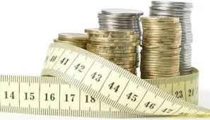 towers-of-coins-surrounded-by-a-measuring-tape.jpg