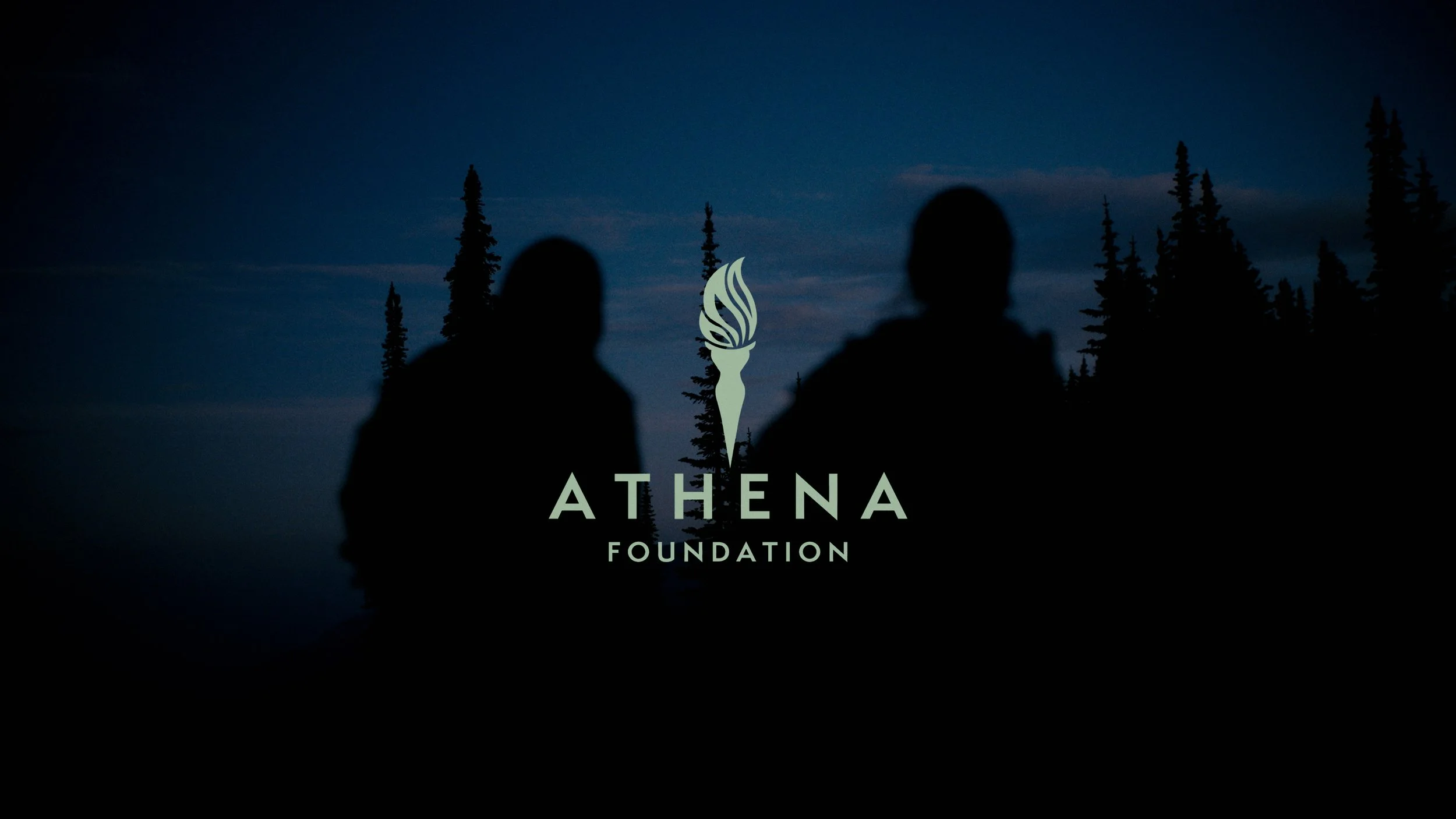 Silhouettes of two people standing outdoors at night with tall pine trees in the background, overlayed with the Athena Foundation logo and text.