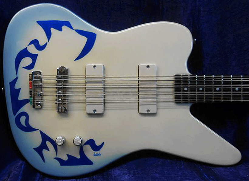 The body wings are basswood with a maple top. Medium 32" scale with Hamer bridge and tailpiece. The bass has one volume control and a stack tone control with bass on bottom and treble on top.