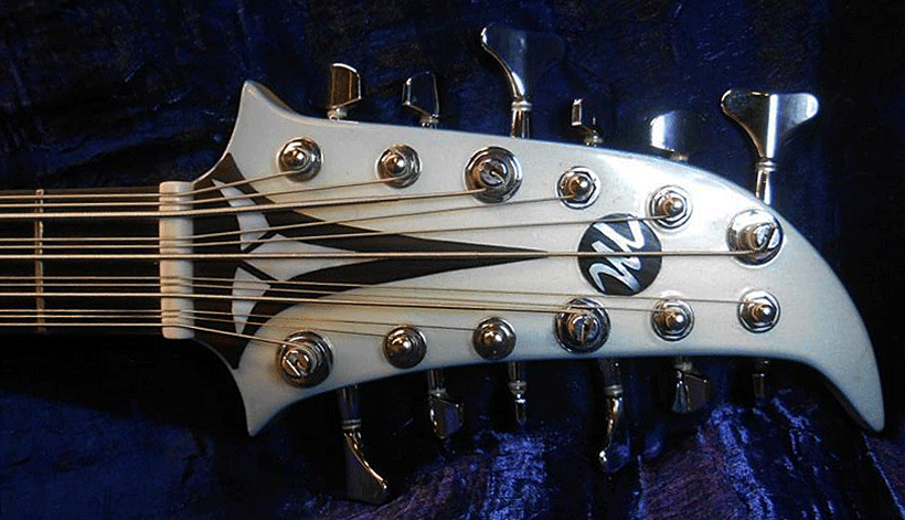 The truss rod cover is the Klingon insignia logo in white mother of pearl inlaid in ebony. It is held on in place by two small magnets. Michael Marino's "M" logo is also mother of pearl inlaid in ebony.