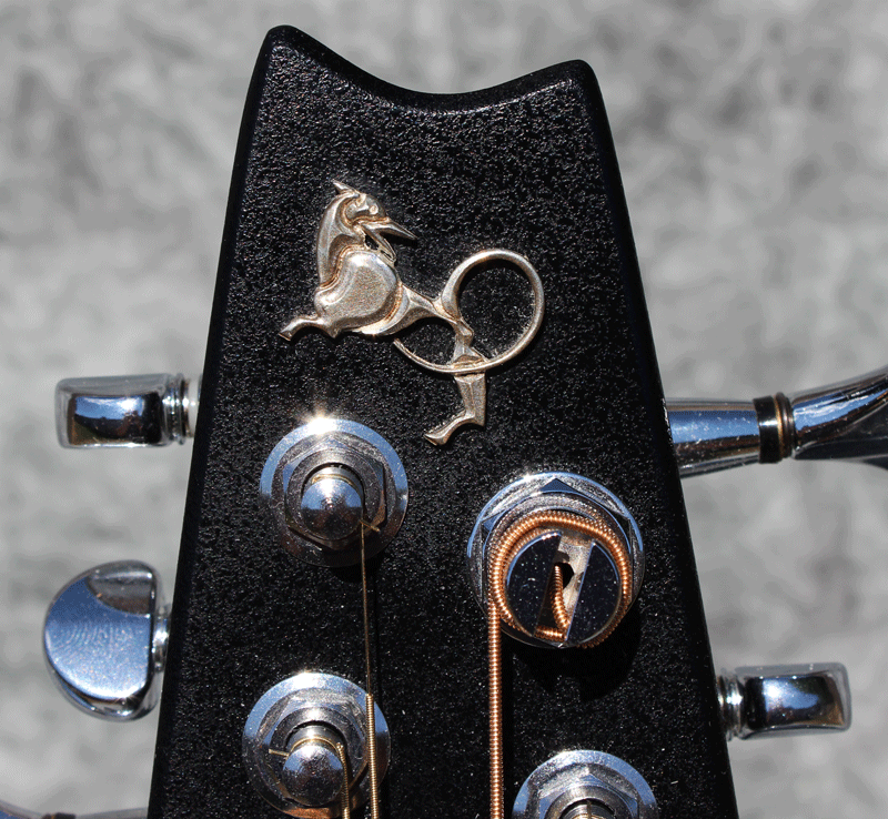 The logo for Emerald Guitars rides on the end of the headstock. I’m not exactly sure what creature this is…