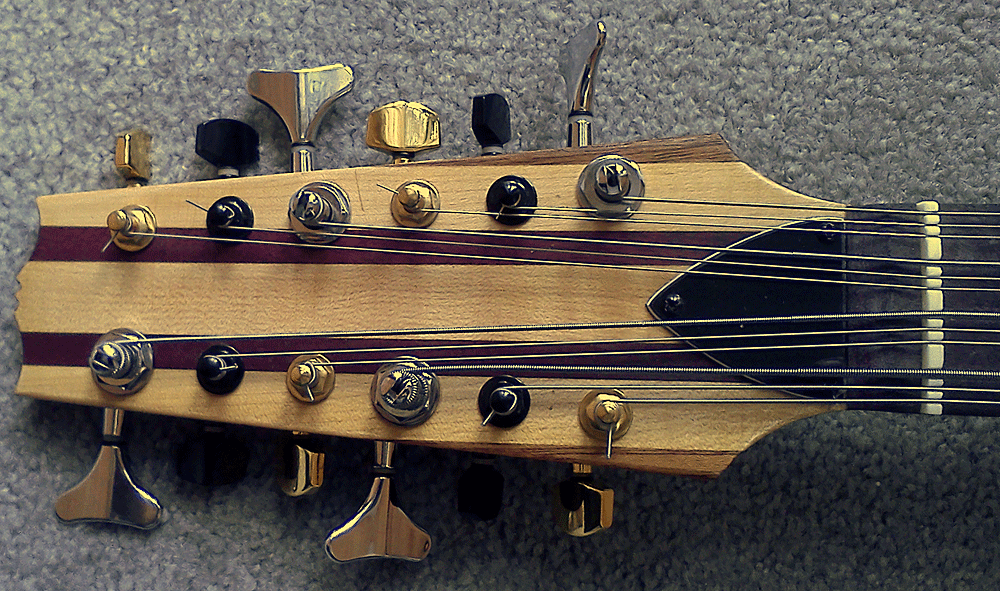 "You may have noticed that it has different color tuning pegs. This is for two reasons. First, we have all broken strings by cranking on the wrong tuner. This way you go for the corresponding color and you always get it right. The other reason is it actually looks less insane than matching color pickups. I don't know why."