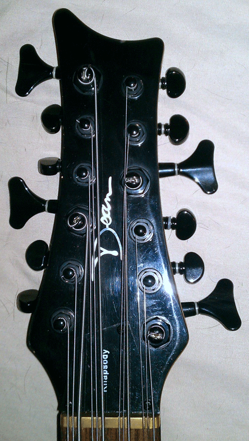 The first series basses have the Dean logo centered between the tuners.