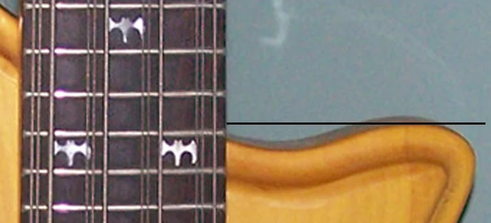 The body on Type 1 basses extends nearly straight down the neck with only a slight dip.