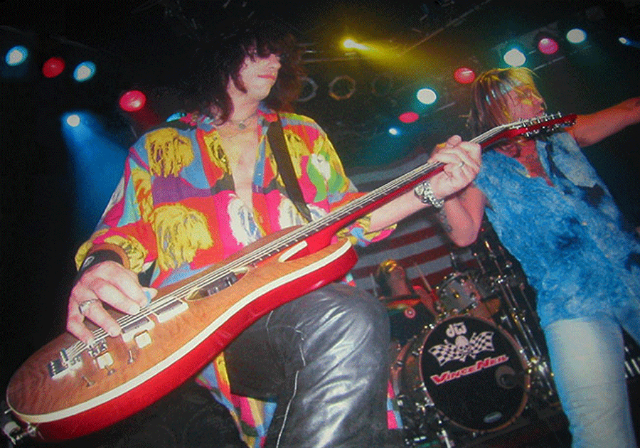 James Hunting on stage with his Hamer B12A 12-string bass and Vince Neil.