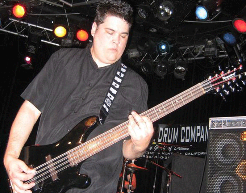 Arthur Persson on stage with a Waterstone Ozone 12-string bass that has been custom painted black.
