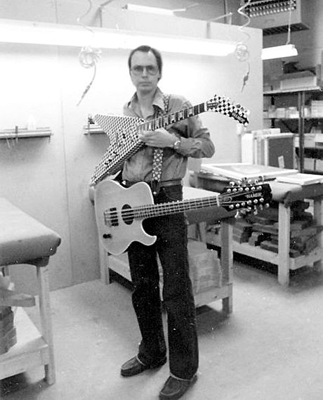 Jol Dantzig at the Hamer shop in Palatine, Illinois with the first Hamer single cutaway B12A 12-string bass (made for Tom Petersson) and Rick Nielsen's checkerboard Vector guitar, January, 1979.