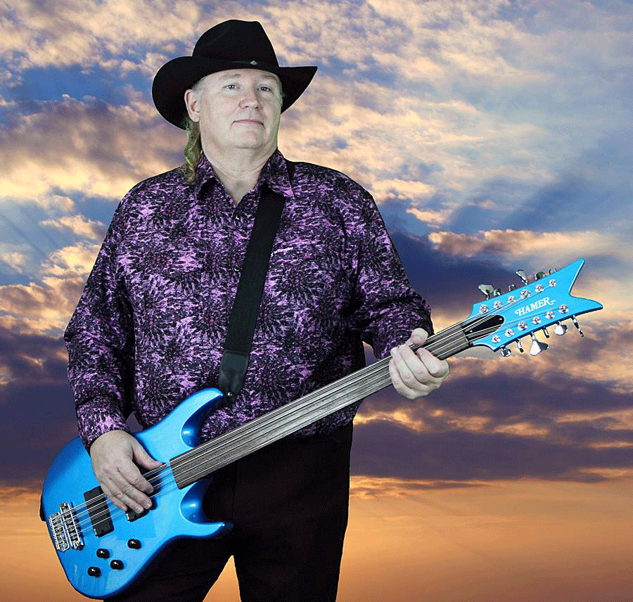 Mark “Surf” Rowe and his Hamer fretless B12L 12-string bass in the Candy Blue custom finish. Surf says, “I rented out North Dakota to get this background - you’d be amazed at how inexpensive that is on a week day!”